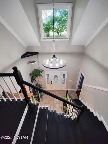 a view of a living room and chandelier