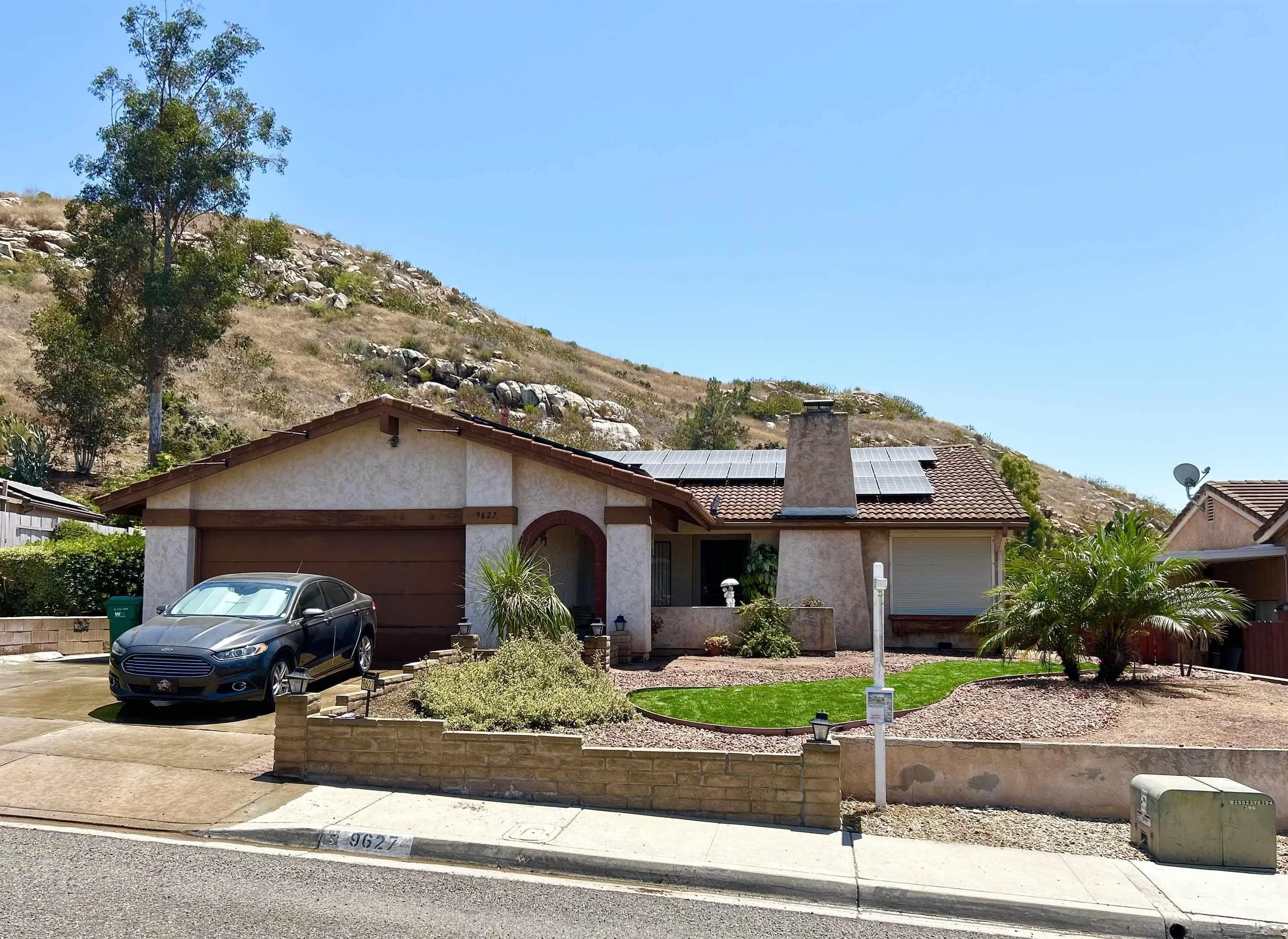 9627 Ramsgate Way Santee, CA 92071 - Photo 1 of 21 a view of a car parked in front of a brick house with large windows