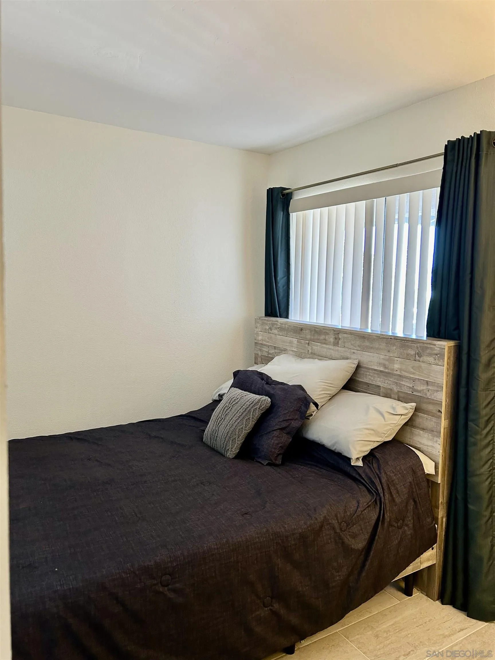 9627 Ramsgate Way Santee, CA 92071 - Photo 12 of 21 a bedroom with a bed and wooden floor