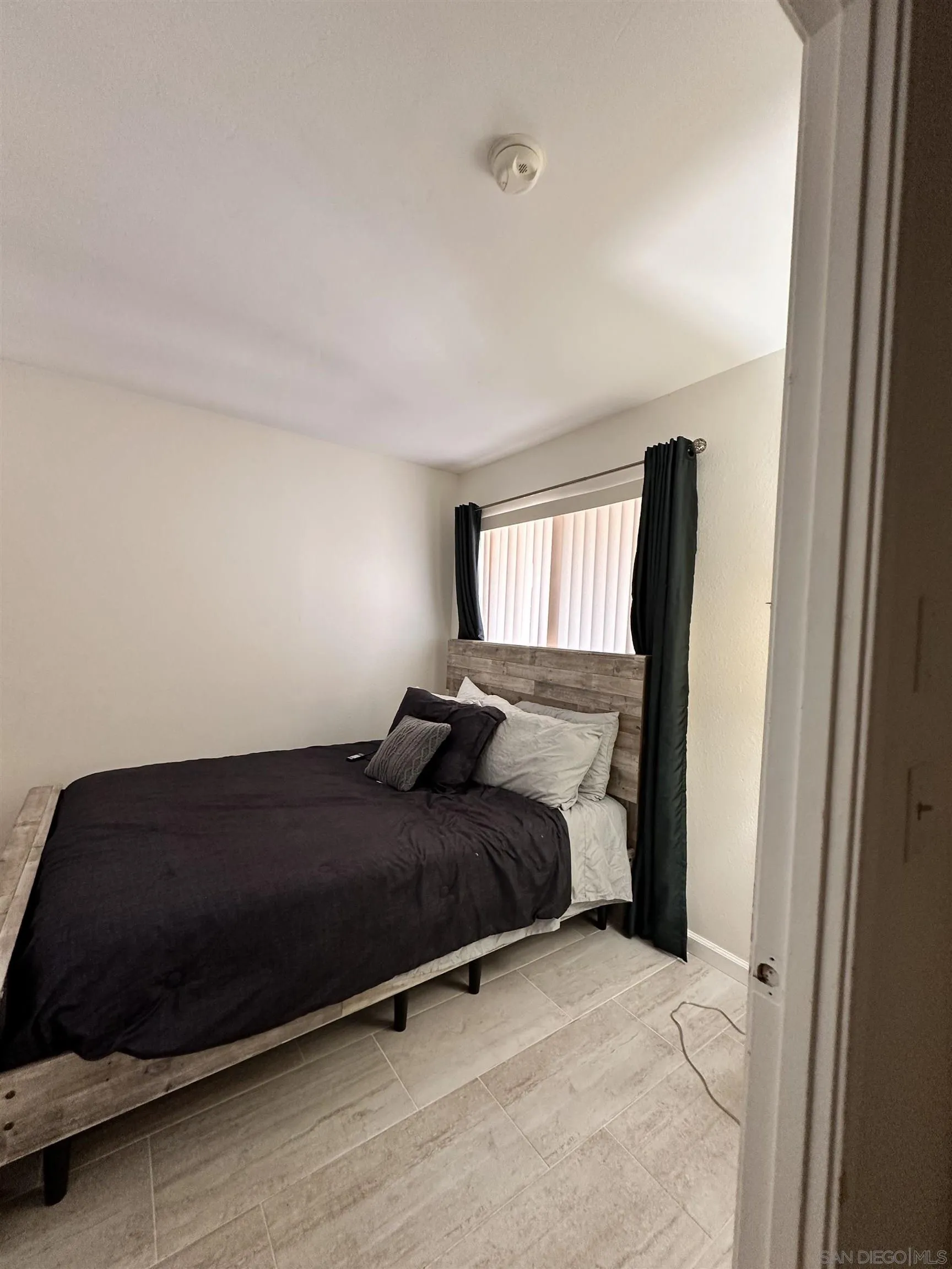 9627 Ramsgate Way Santee, CA 92071 - Photo 2 of 21 a bedroom with a bed and wooden floor