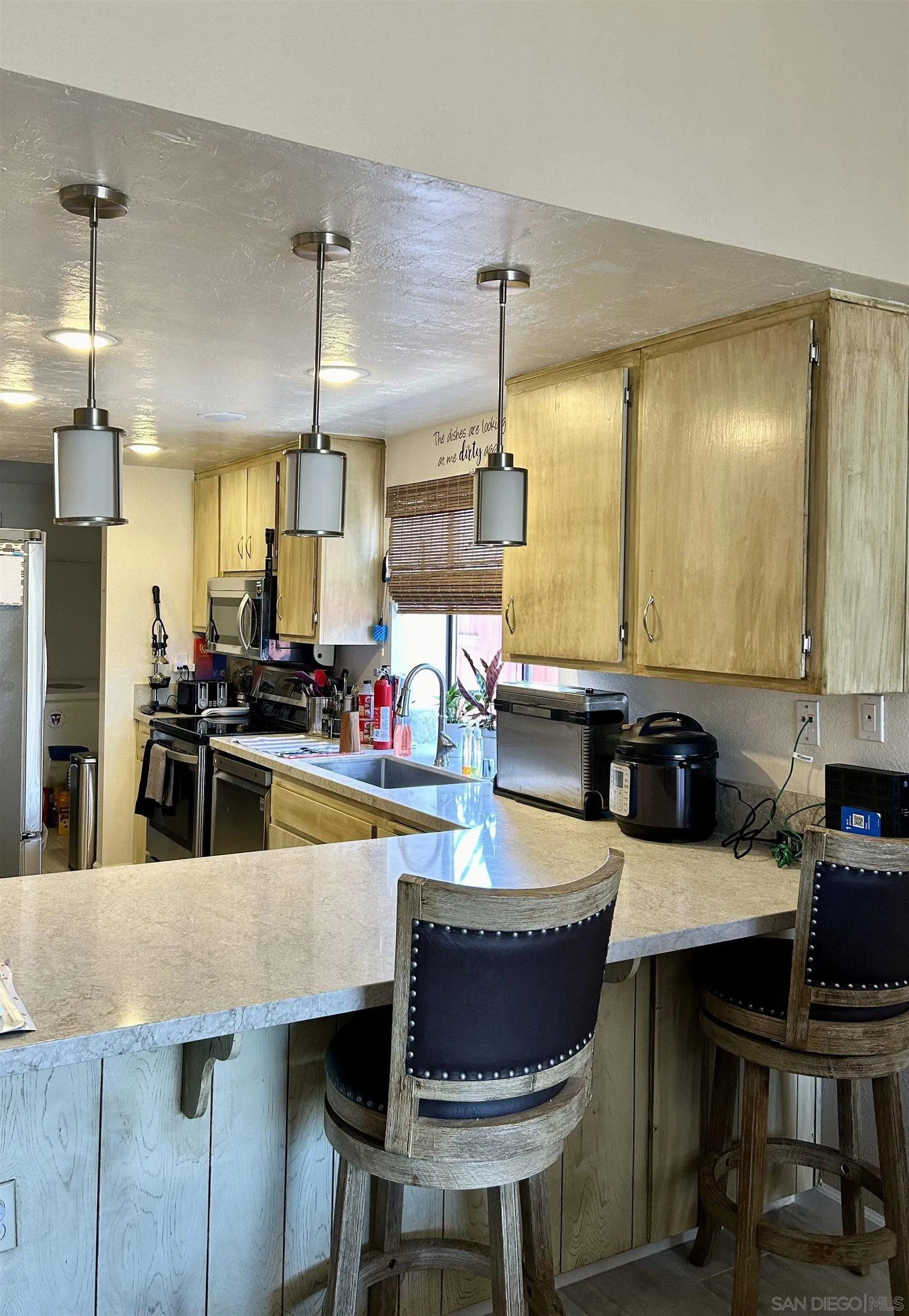 9627 Ramsgate Way Santee, CA 92071 - Photo 21 of 21 a large kitchen with a table and chairs