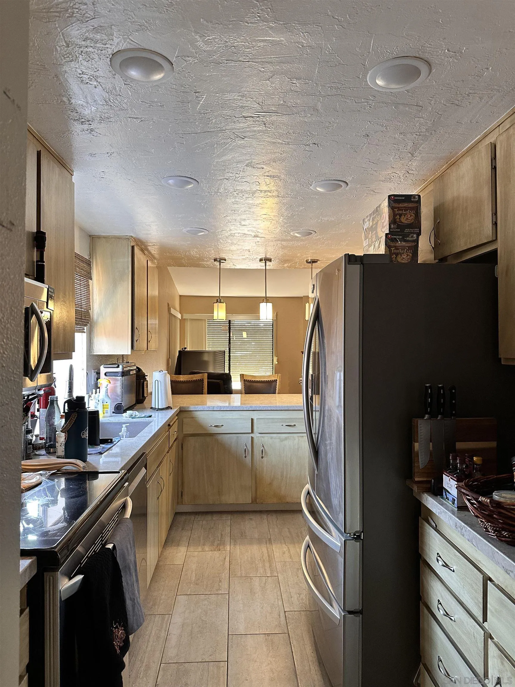9627 Ramsgate Way Santee, CA 92071 - Photo 5 of 21 a kitchen with granite countertop stainless steel appliances and a sink