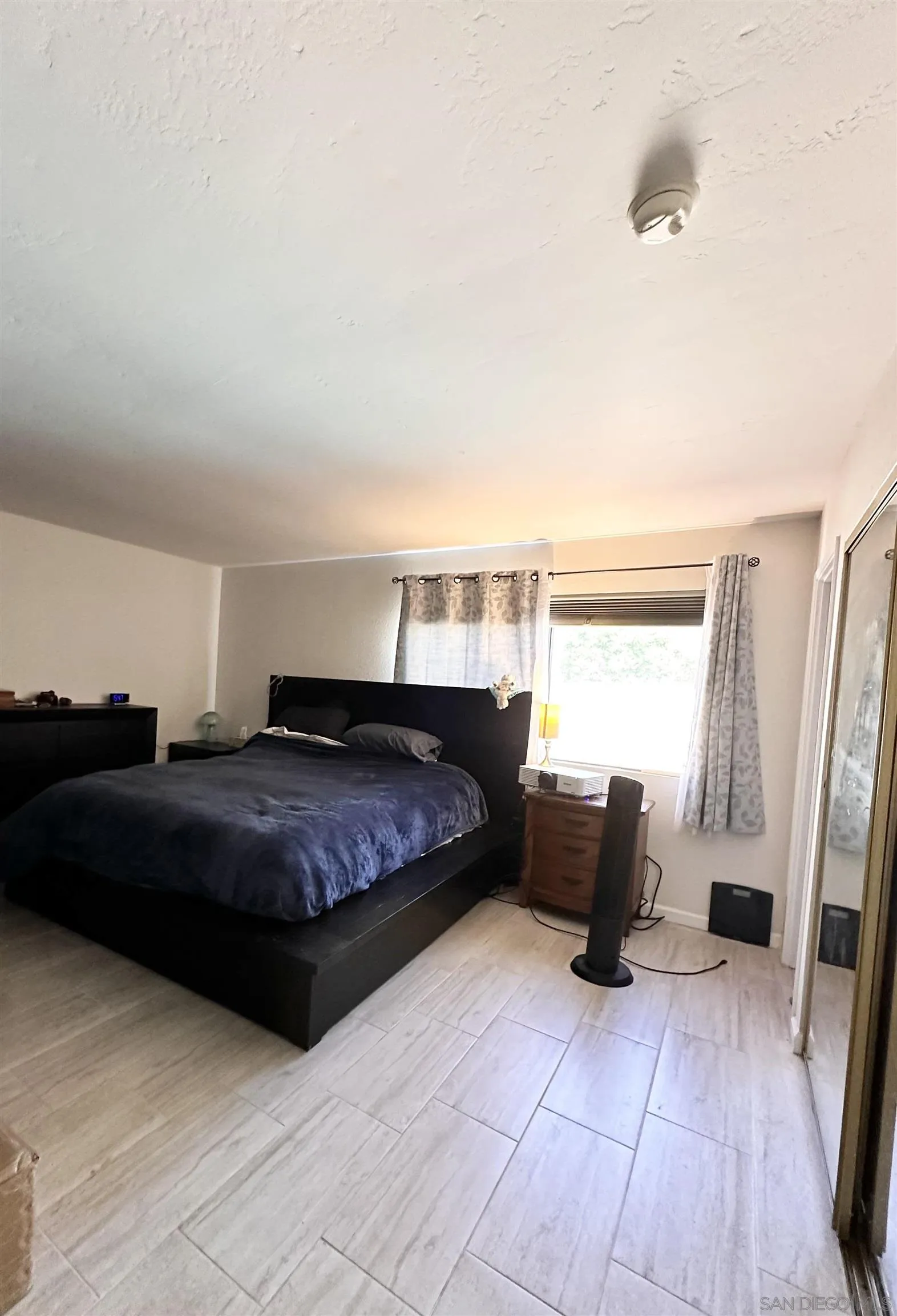 9627 Ramsgate Way Santee, CA 92071 - Photo 8 of 21 a bedroom with a bed and wooden floor