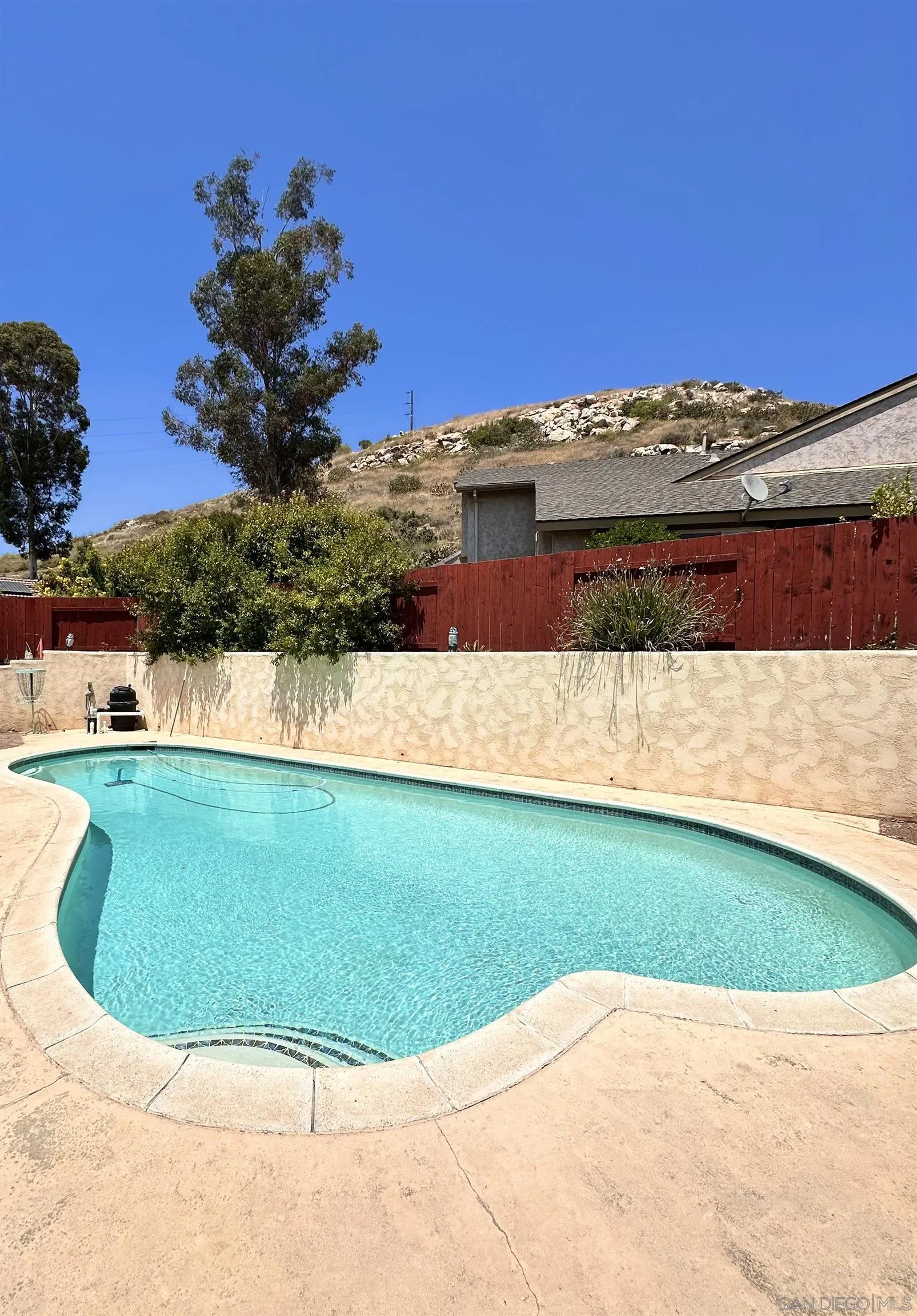 9627 Ramsgate Way Santee, CA 92071 - Photo 9 of 21 a view of a swimming pool with a yard