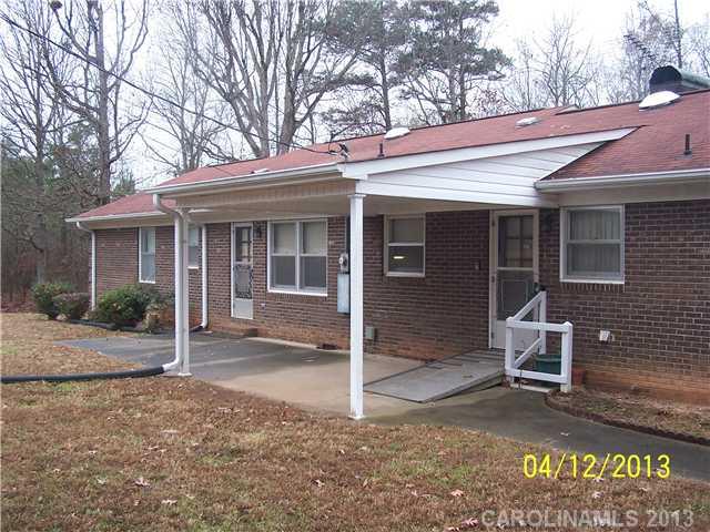 2119 Lathan Road Monroe, NC 28112 - Photo 2 of 16 a view of a house with a yard and sitting area