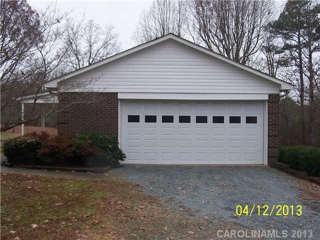 2119 Lathan Road Monroe, NC 28112 - Photo 12 of 16 a front view of a house with garden