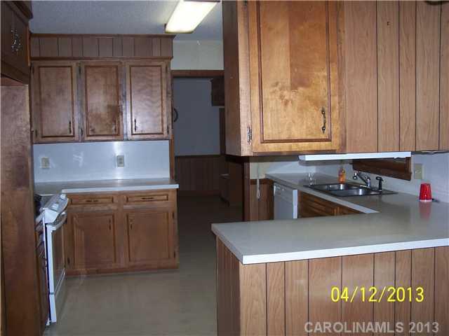2119 Lathan Road Monroe, NC 28112 - Photo 3 of 16 a kitchen with a sink and a refrigerator