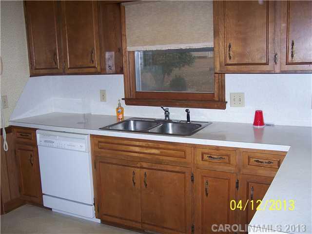 2119 Lathan Road Monroe, NC 28112 - Photo 4 of 16 a kitchen with stainless steel appliances granite countertop a sink and a microwave