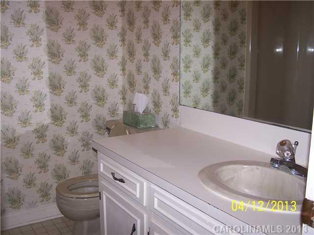 2119 Lathan Road Monroe, NC 28112 - Photo 9 of 16 a bathroom with a granite countertop sink and a mirror