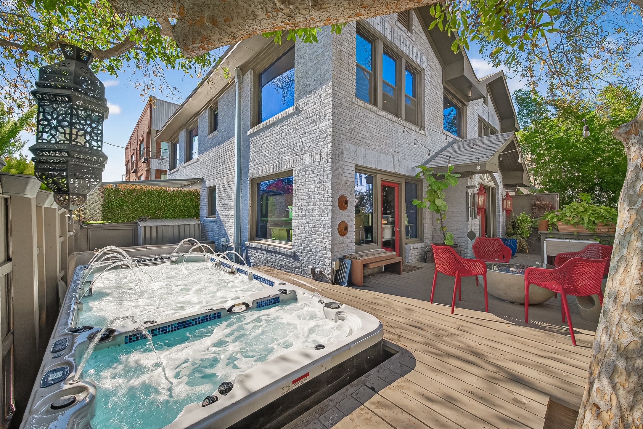 301 West Clay Street Houston, TX 77019 - Photo 5 of 24 Private outdoor spa designed for entertaining, featuring a spacious deck and multiple-jet hot tub with full-size swim spa. Perfect for hosting guests or unwinding in a secluded, resort-style setting.