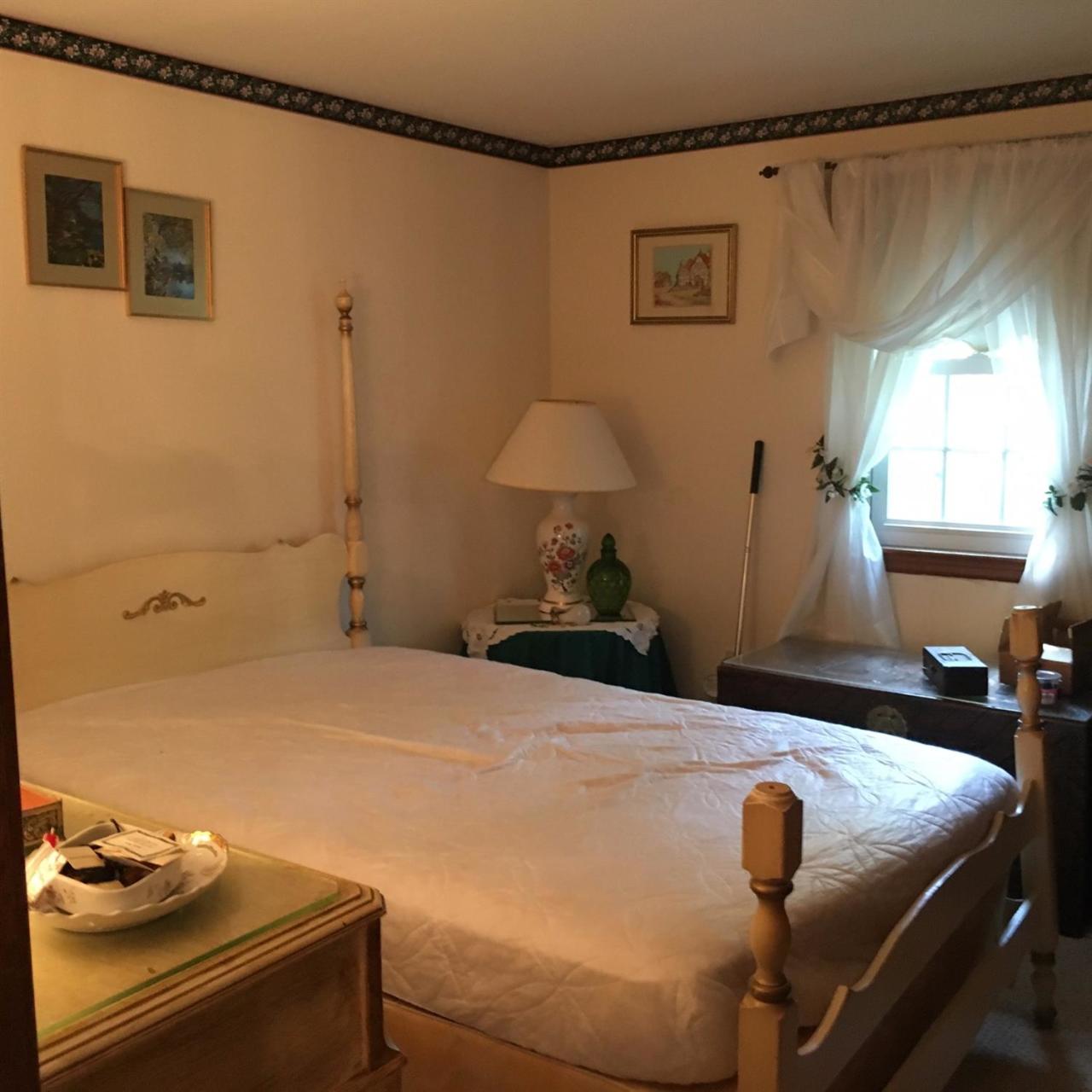 343 Cotuit Road Mashpee, MA 02649 - Photo 8 of 11 a bedroom with a bed and a table in it