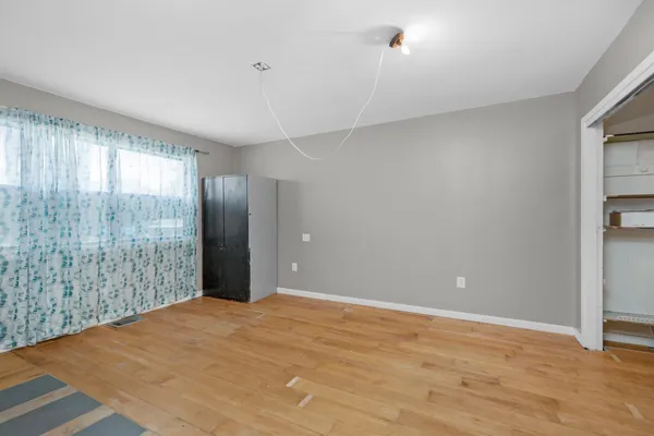 a view of an empty room with glass door