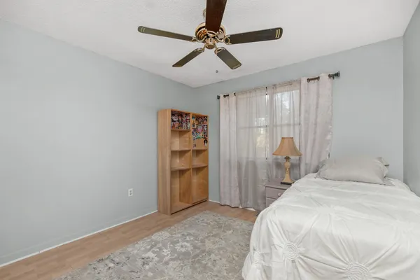 a bedroom with a bed and a chandelier