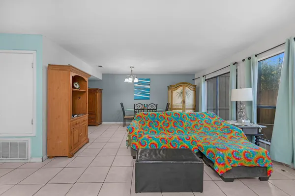 a bedroom with a bed and dresser with mirror