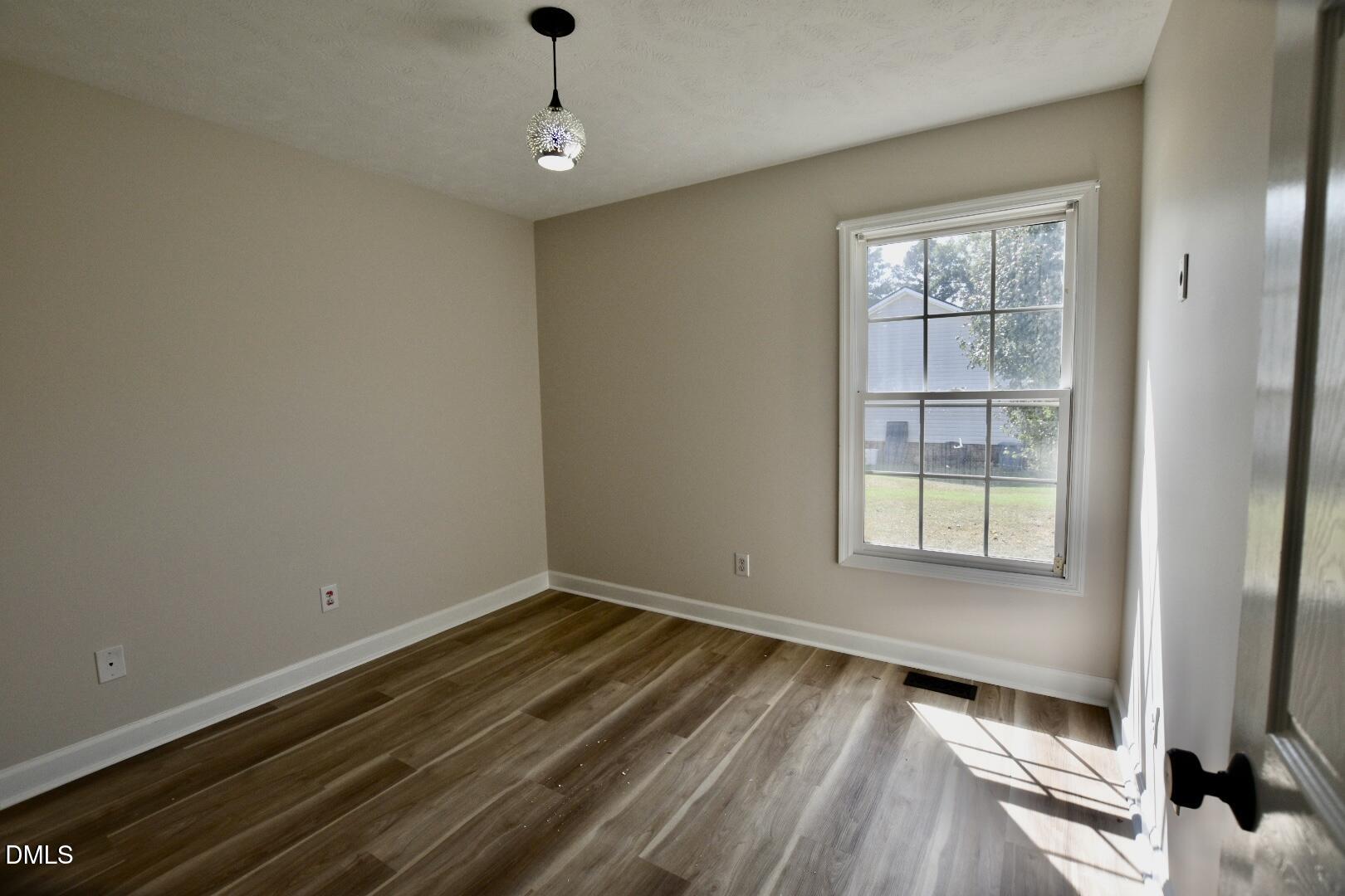 879 O B J Road Dunn, NC 28334 - Photo 10 of 23 a view of wooden floor and windows in a room