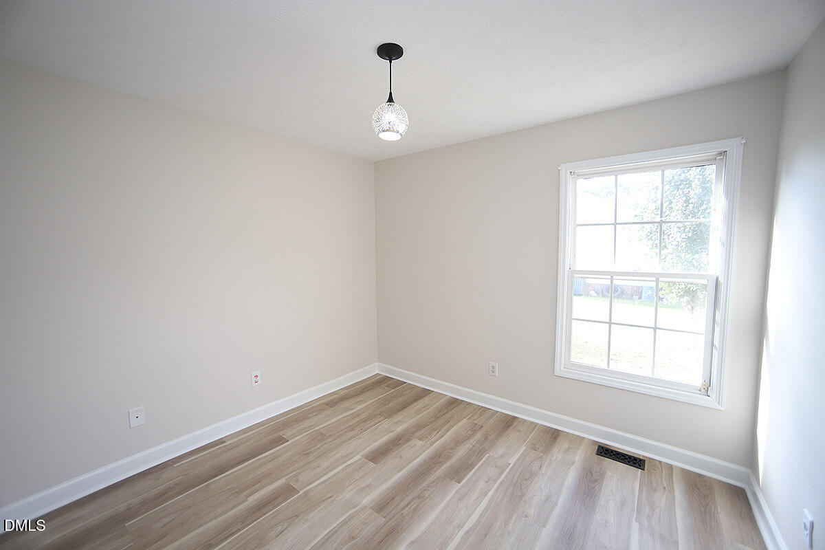 879 O B J Road Dunn, NC 28334 - Photo 15 of 23 wooden floor in an empty room with a window