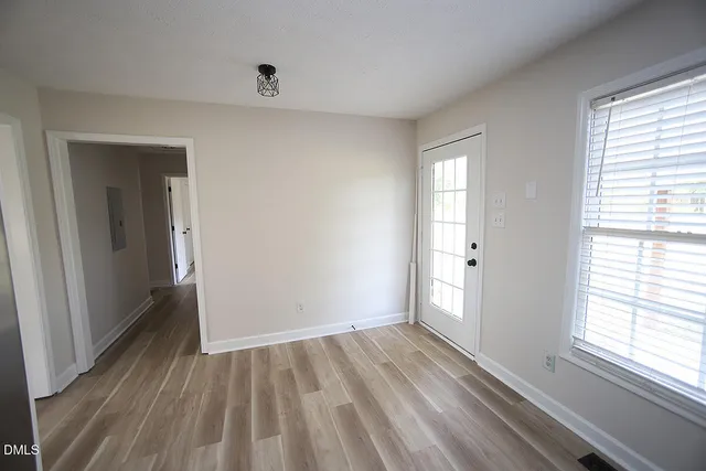 wooden floor in an empty room with a window