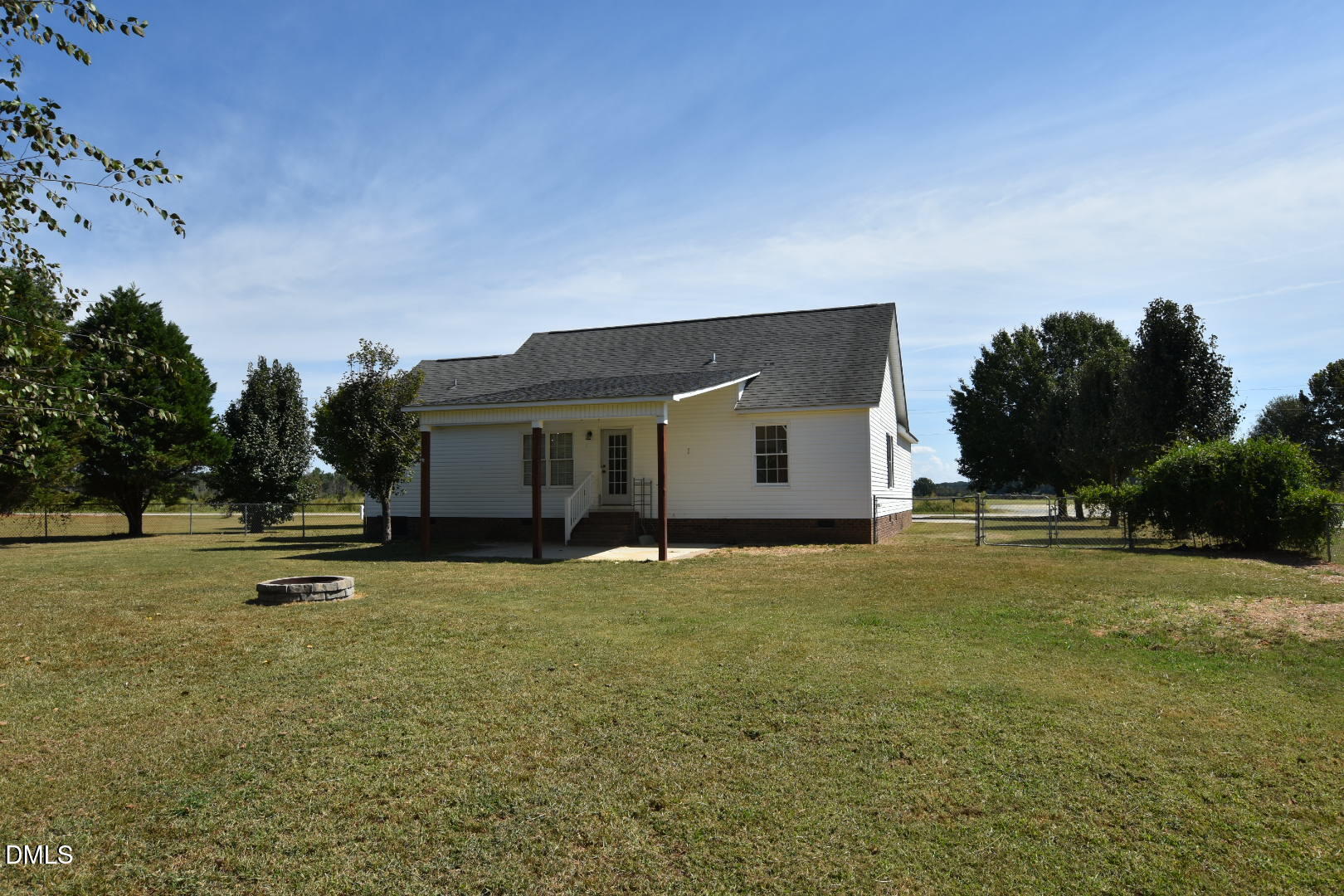 879 O B J Road Dunn, NC 28334 - Photo 3 of 23 a backyard of a house with table and chairs