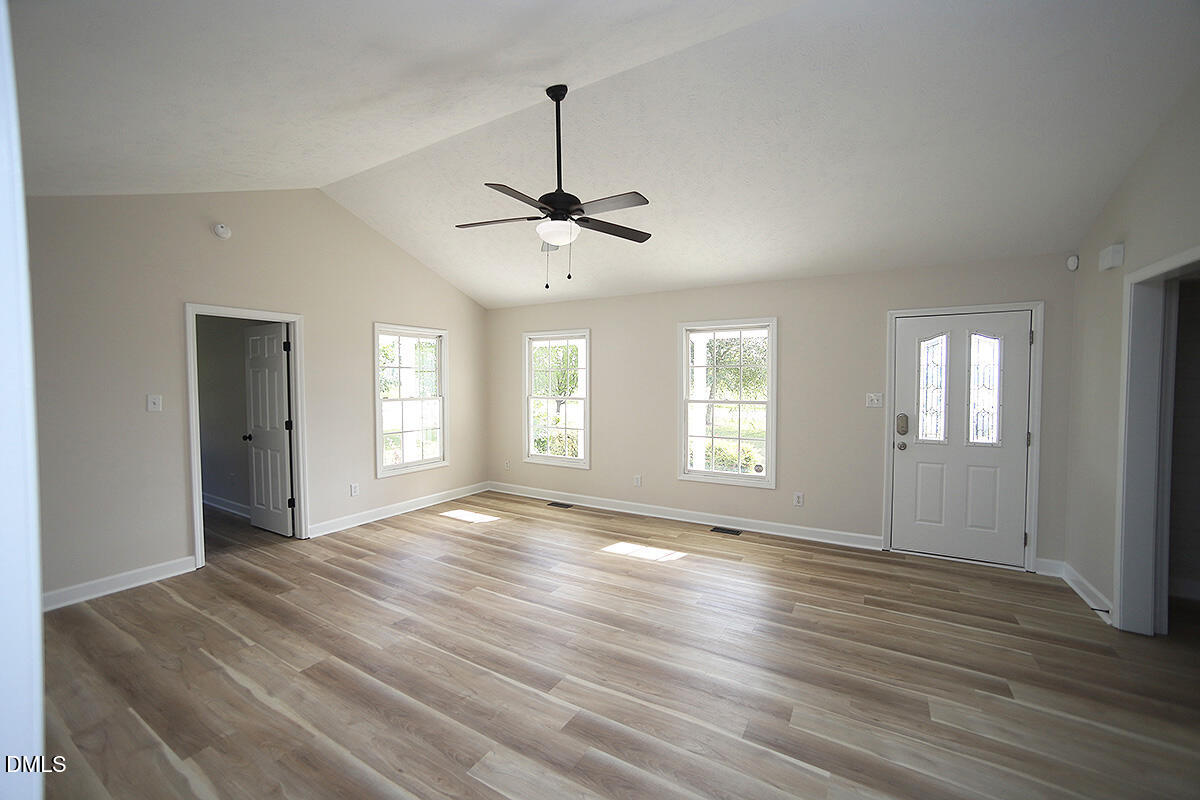 879 O B J Road Dunn, NC 28334 - Photo 7 of 23 a view of an empty room with window and wooden floor