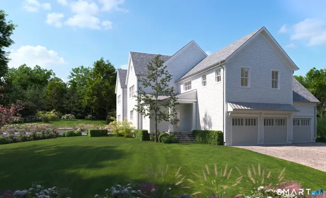 a front view of a house with a yard and trees