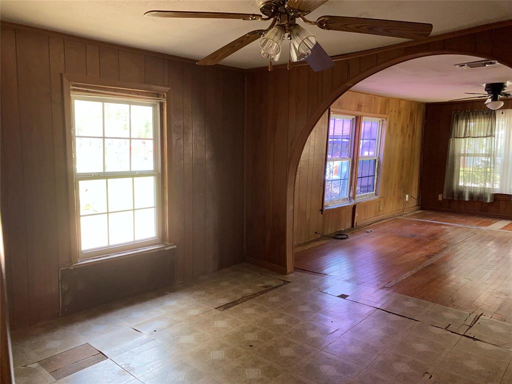 811 West 12th Street, Unit 815 Bonham, TX 75418 - Photo 13 of 23 an empty room with chandelier fan and windows
