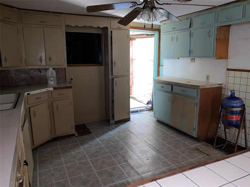 811 West 12th Street, Unit 815 Bonham, TX 75418 - Photo 23 of 23 a kitchen with stainless steel appliances granite countertop a sink and a refrigerator