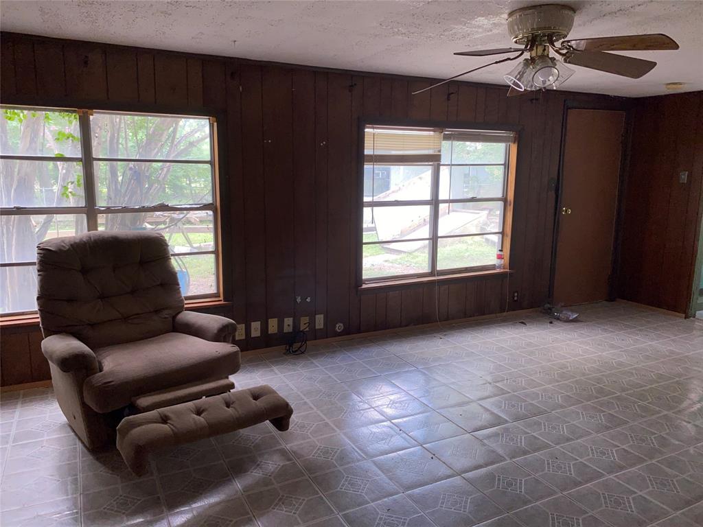 811 West 12th Street, Unit 815 Bonham, TX 75418 - Photo 8 of 23 a living room with furniture a window and a ceiling fan
