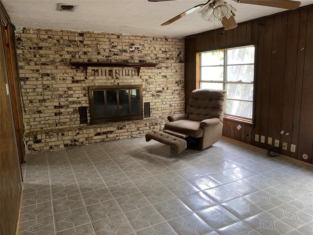 811 West 12th Street, Unit 815 Bonham, TX 75418 - Photo 9 of 23 a living room with furniture a flat screen tv and a fireplace