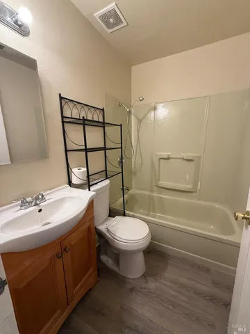 a bathroom with a sink toilet a mirror and shower