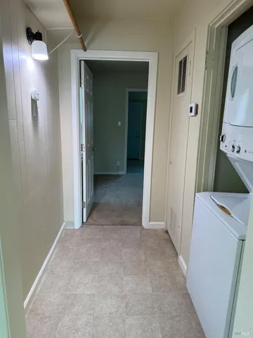 a view of a hallway with closet and wooden floor