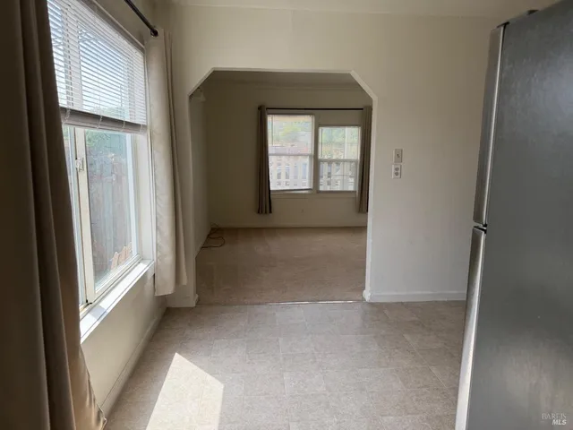 a view of an empty room with a fireplace