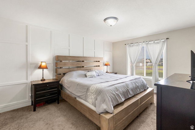 2485 South 1100th Street West Logan, UT 84321 - Photo 19 of 53 Bedroom featuring board and batten accent wall, neutral carpeting, and a window with blinds