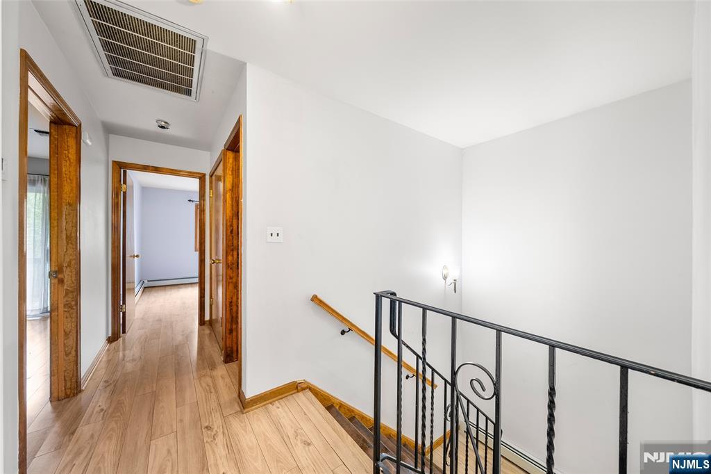 140 Allwood Road, Unit C Clifton, NJ 07012 - Photo 19 of 31 a view of a hallway with wooden floor and staircase