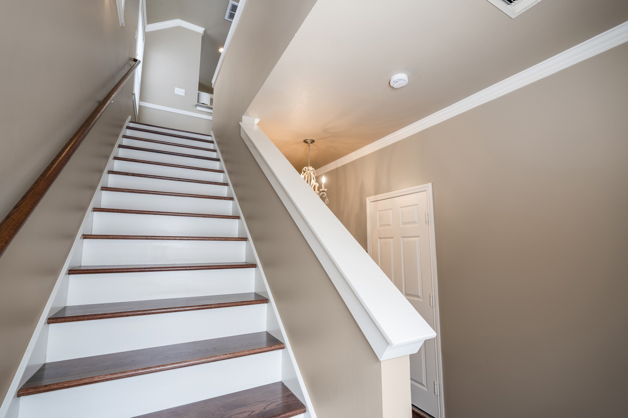3209 Chenevert Street Houston, TX 77004 - Photo 16 of 32 Staircase leading to the second-floor living level, connecting the open living and dining areas, kitchen, secondary bedroom, full bathroom, and utility room—designed for functional flow and comfortable Midtown Houston townhome living.