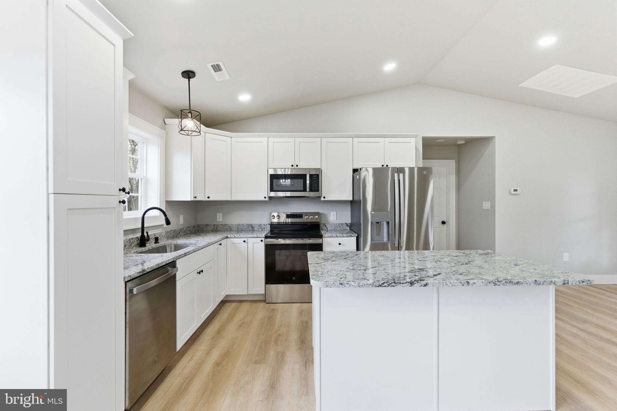 14 Anderson Court Berkeley Springs, WV 25411 - Photo 11 of 52 a large kitchen with granite countertop a sink stainless steel appliances and cabinets