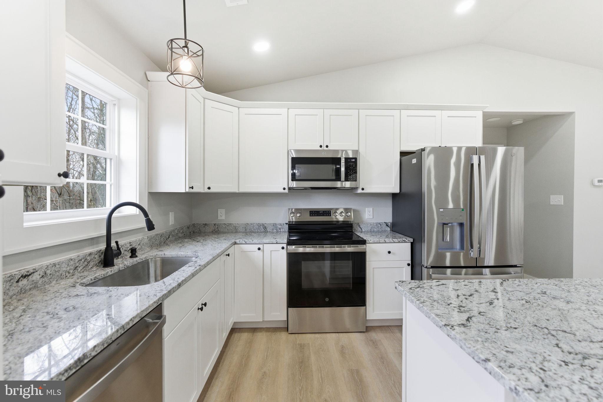 14 Anderson Court Berkeley Springs, WV 25411 - Photo 12 of 52 a kitchen with stainless steel appliances granite countertop a sink stove and refrigerator