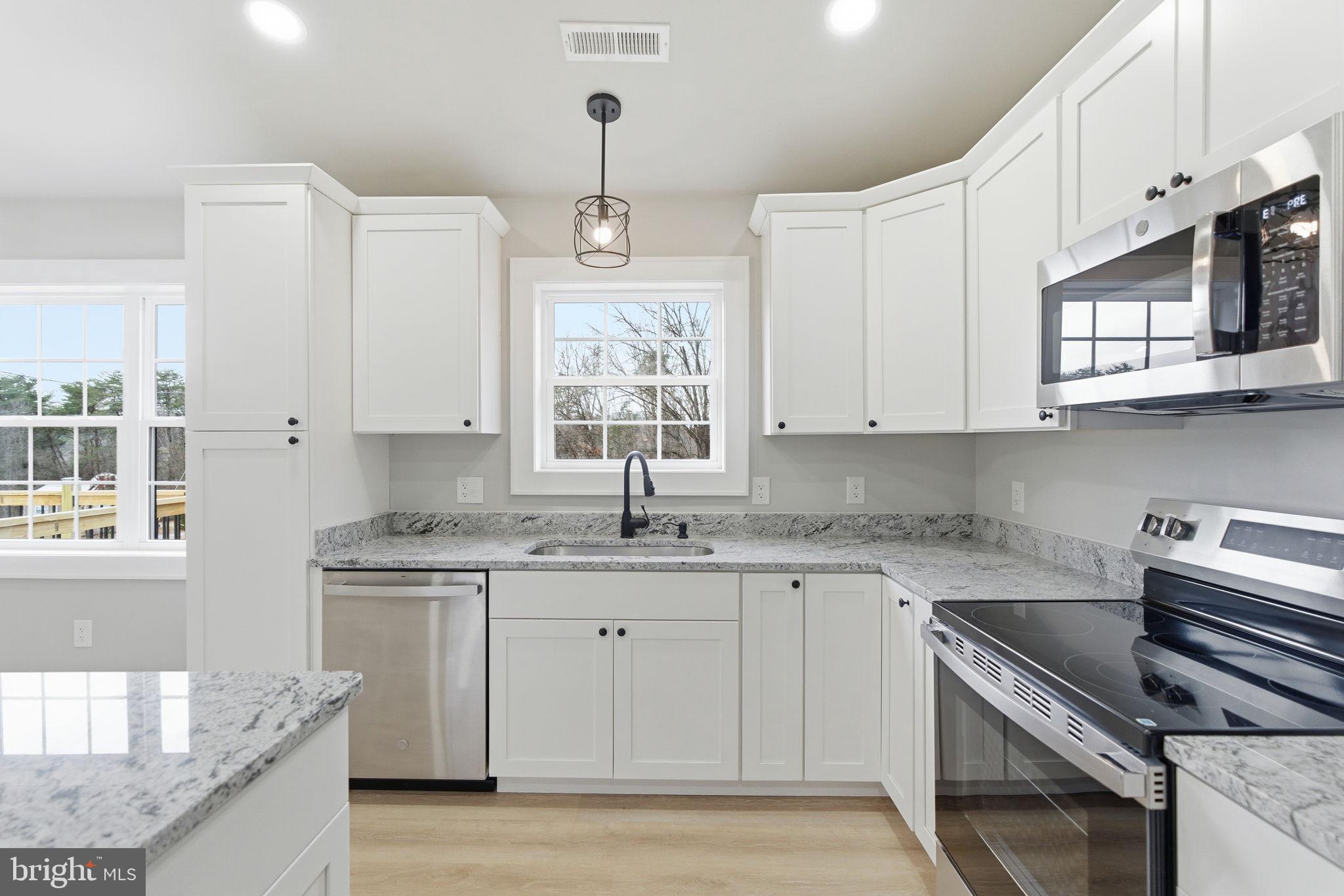 14 Anderson Court Berkeley Springs, WV 25411 - Photo 13 of 52 a kitchen with stainless steel appliances granite countertop a sink stove and cabinets