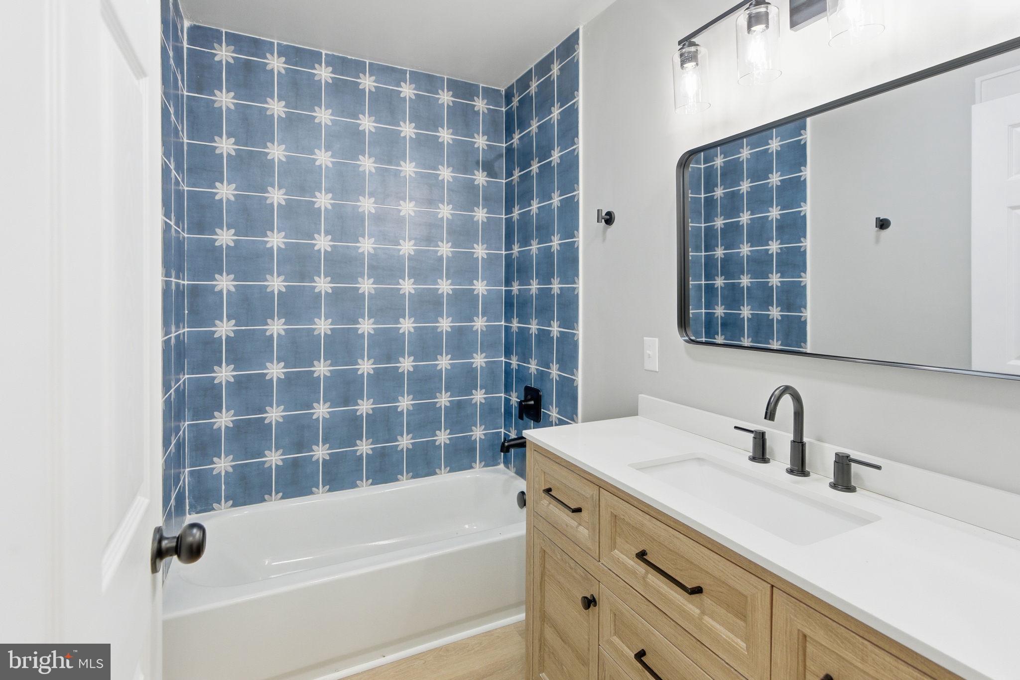 14 Anderson Court Berkeley Springs, WV 25411 - Photo 23 of 52 a bathroom with a tub sink and mirror