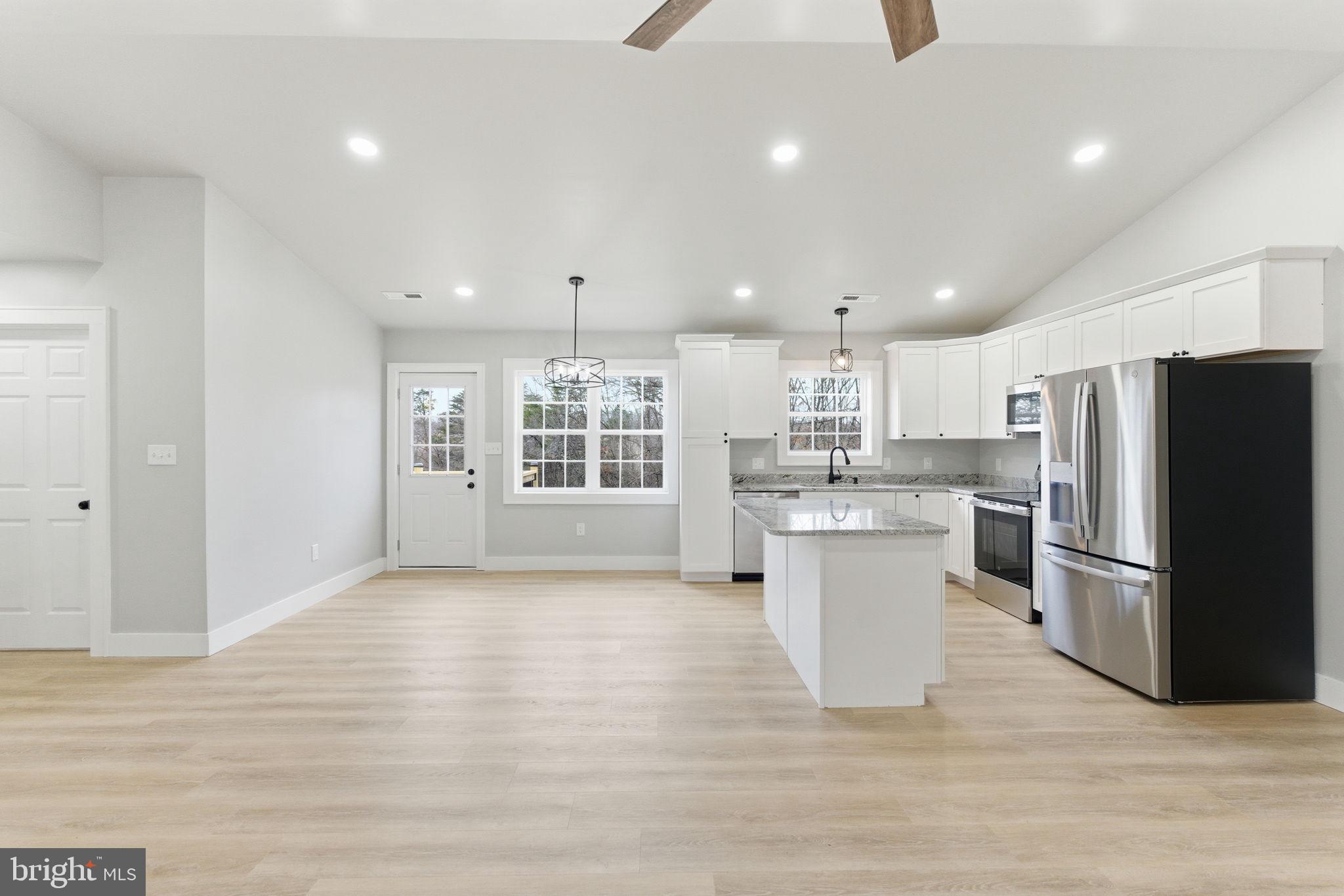 14 Anderson Court Berkeley Springs, WV 25411 - Photo 4 of 52 a kitchen with refrigerator and cabinets