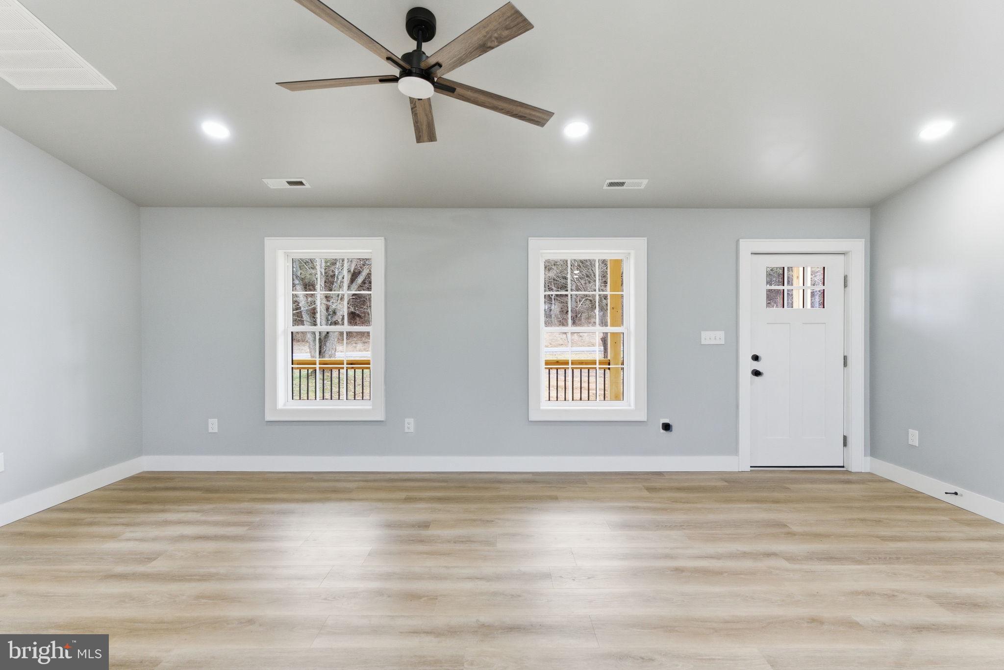 14 Anderson Court Berkeley Springs, WV 25411 - Photo 7 of 52 a view of an empty room with wooden floor and a window