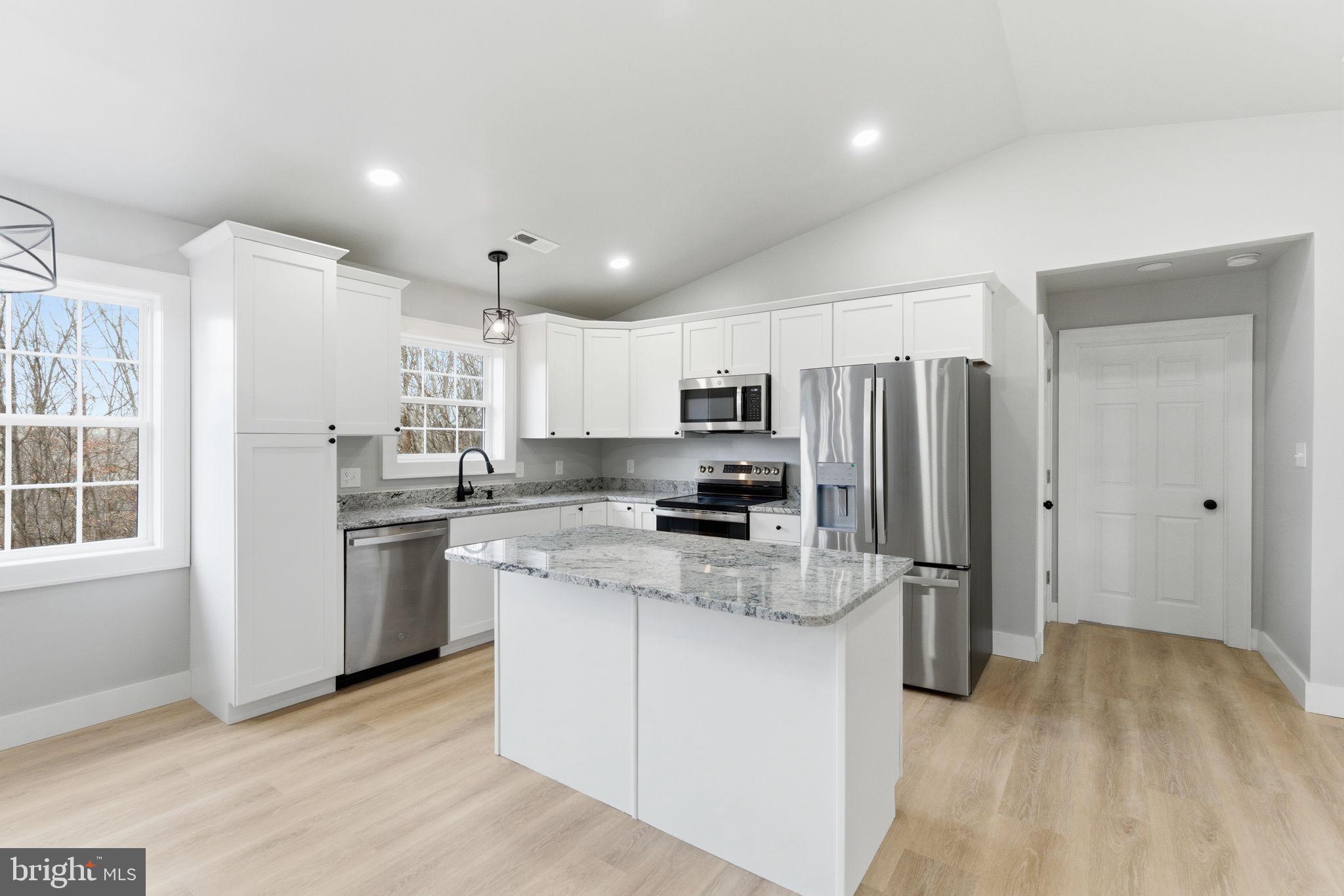 14 Anderson Court Berkeley Springs, WV 25411 - Photo 10 of 52 a kitchen with stainless steel appliances a refrigerator stove microwave and sink