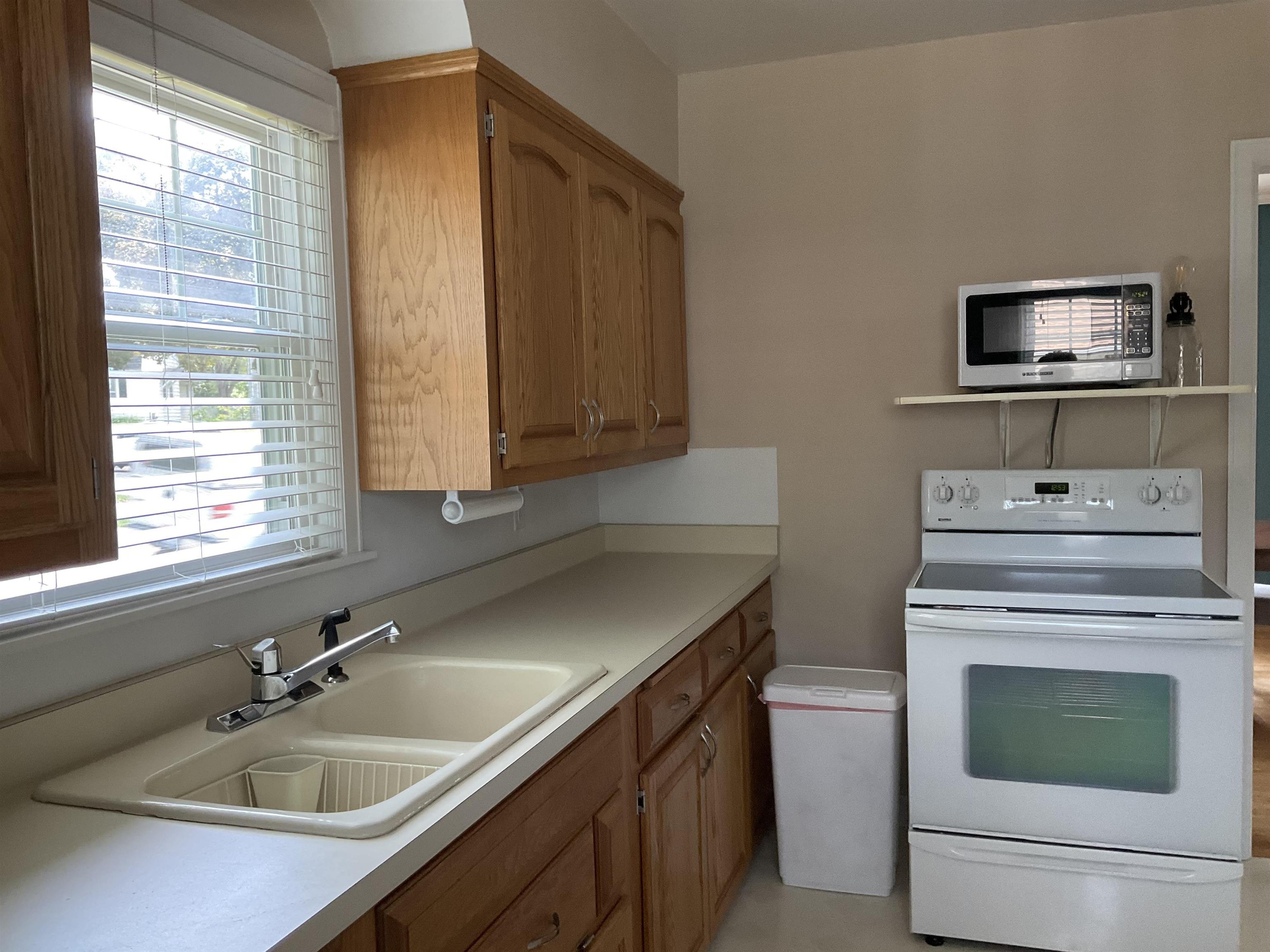 3330 California Road Rockford, IL 61108 - Photo 9 of 29 a kitchen with a sink stove and microwave