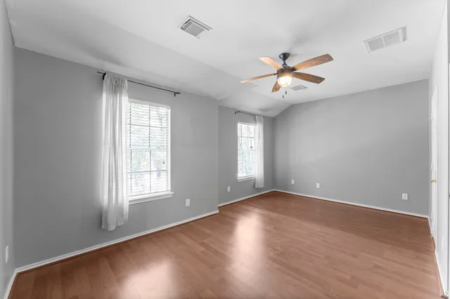 wooden floor in an empty room with a window