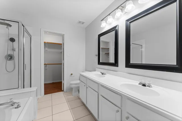 a spacious bathroom with a double vanity sink mirror and double