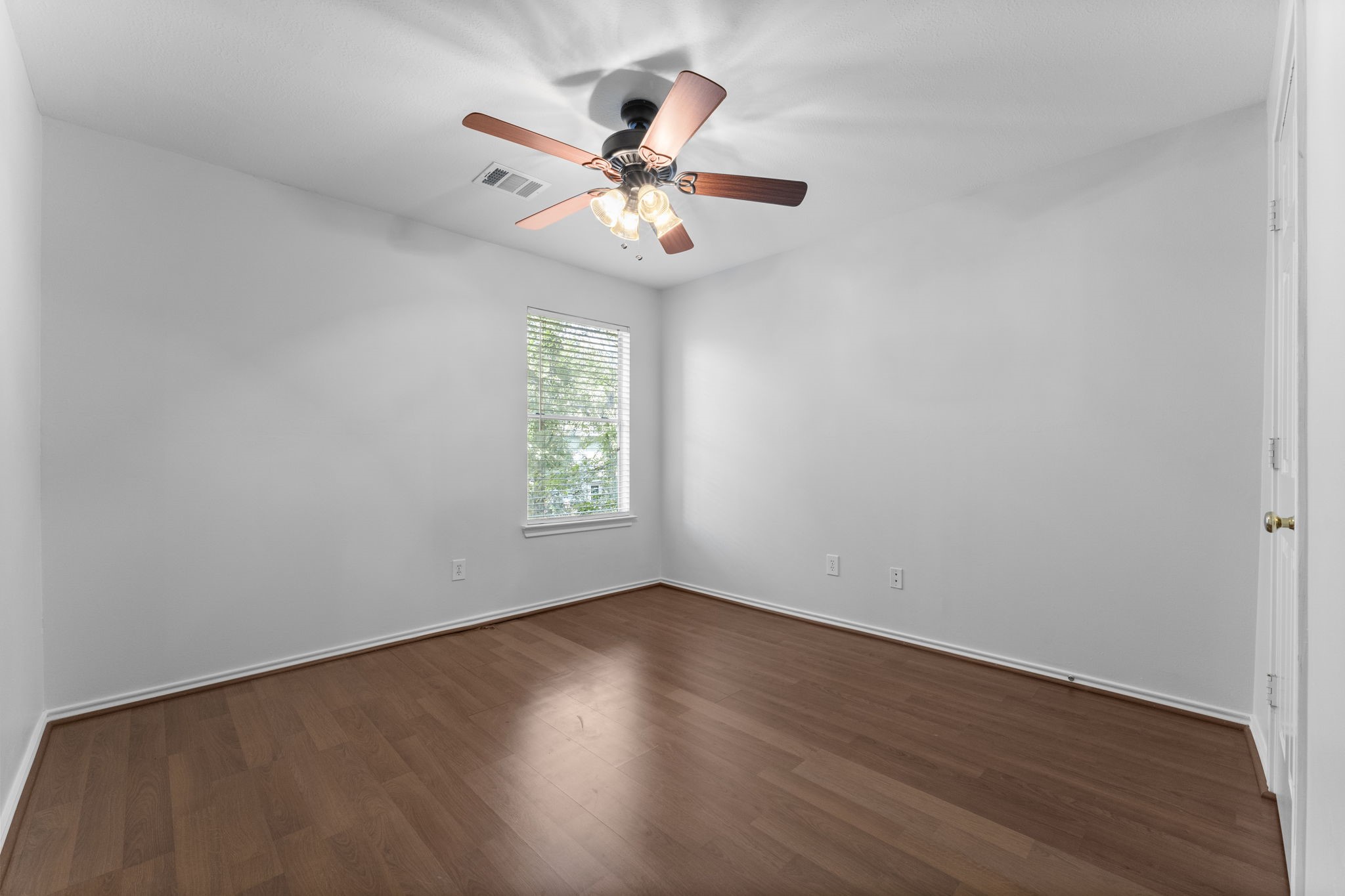 15 Timberstar Street Spring, TX 77382 - Photo 16 of 21 an empty room with wooden floor fan and windows
