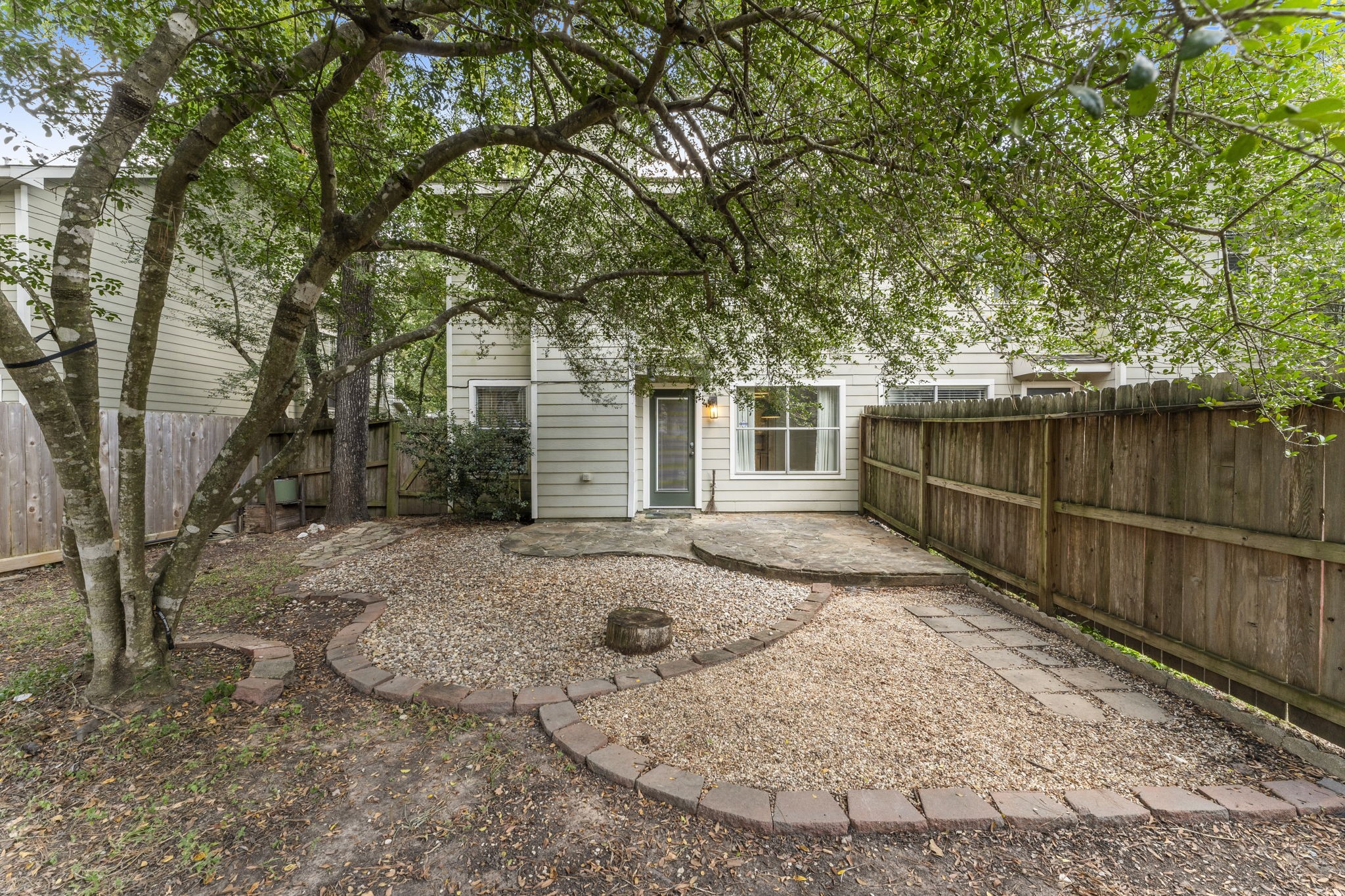 15 Timberstar Street Spring, TX 77382 - Photo 20 of 21 a view of a backyard with large trees and wooden fence