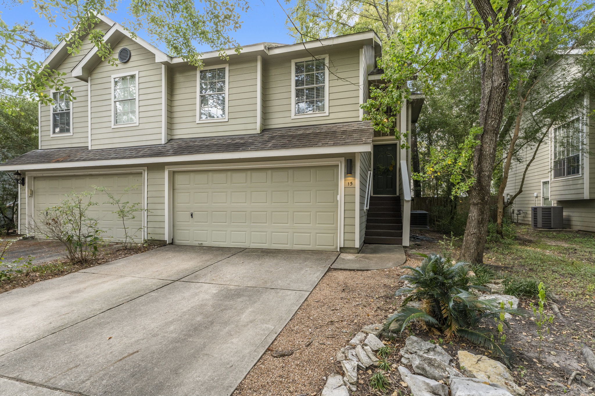 15 Timberstar Street Spring, TX 77382 - Photo 2 of 21 a front view of a house with a yard and garage