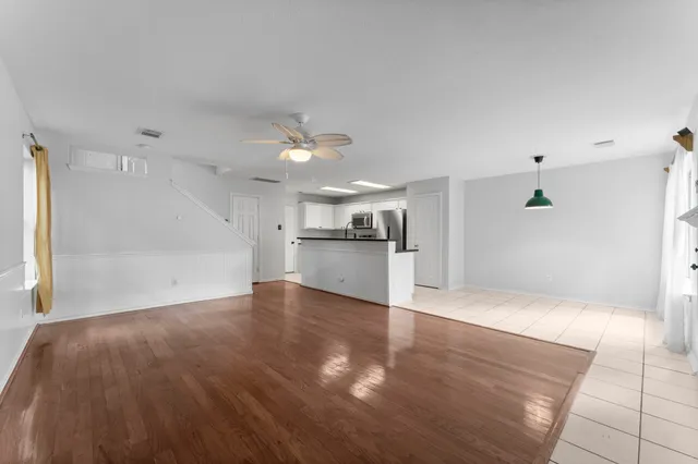 a view of a kitchen with a sink and a refrigerator