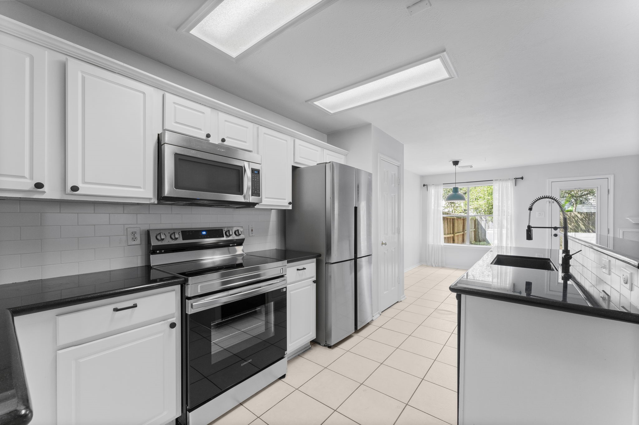 15 Timberstar Street Spring, TX 77382 - Photo 9 of 21 a kitchen with granite countertop a sink appliances and cabinets