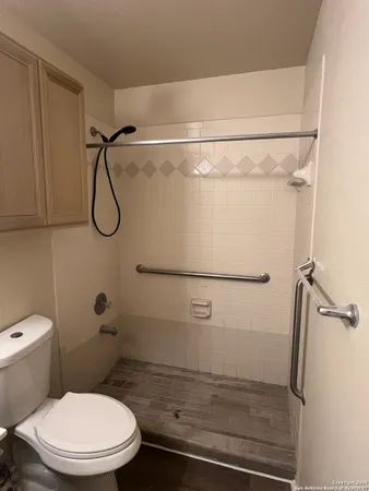 a bathroom with a toilet and a shower
